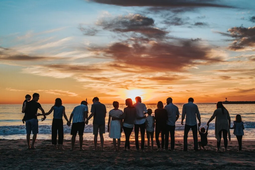 people standing on shore - emotional resonating with during a golden hour