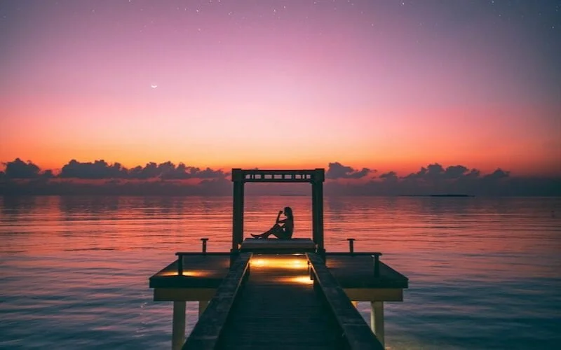people on dock during golden hour