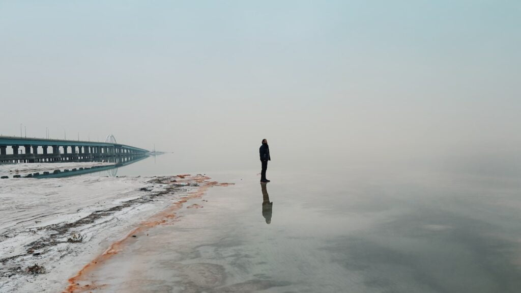 a person standing in the middle of a body of water