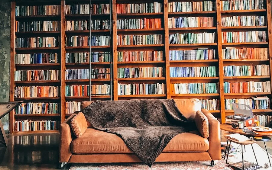 brown wooden book shelves with books