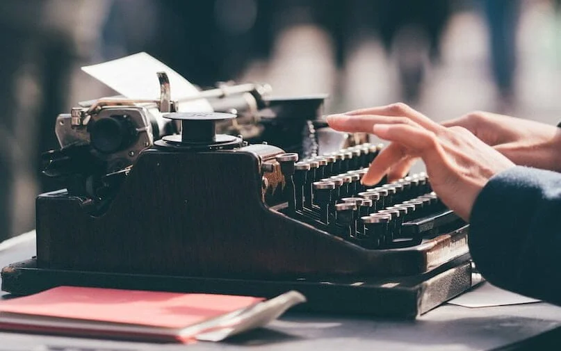 person using black typewriter
