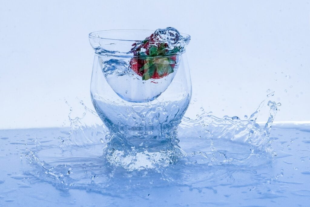 clear glass bowl with red rose petals