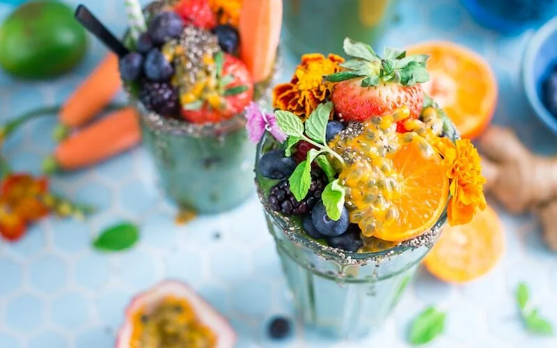 tilt shift lens photography of fruits in drinking glass