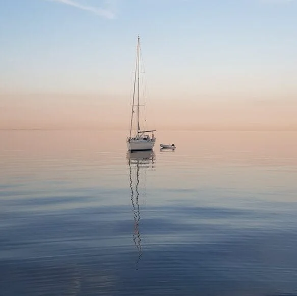 white sailboat at middle of sea