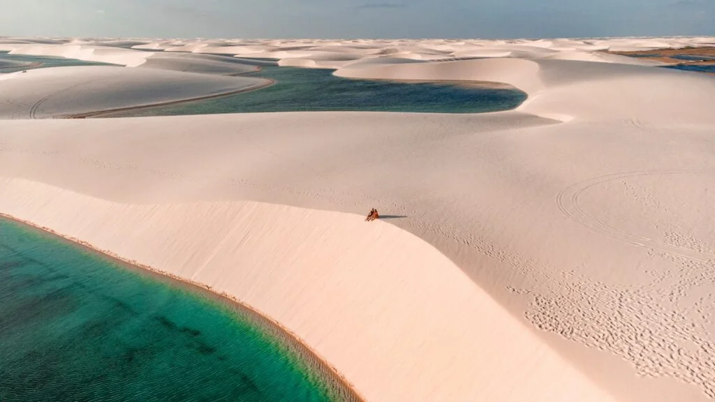 a person standing on top of a sandy beach