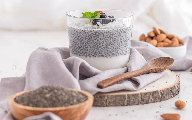 a glass cup with a plant in it and a spoon in it