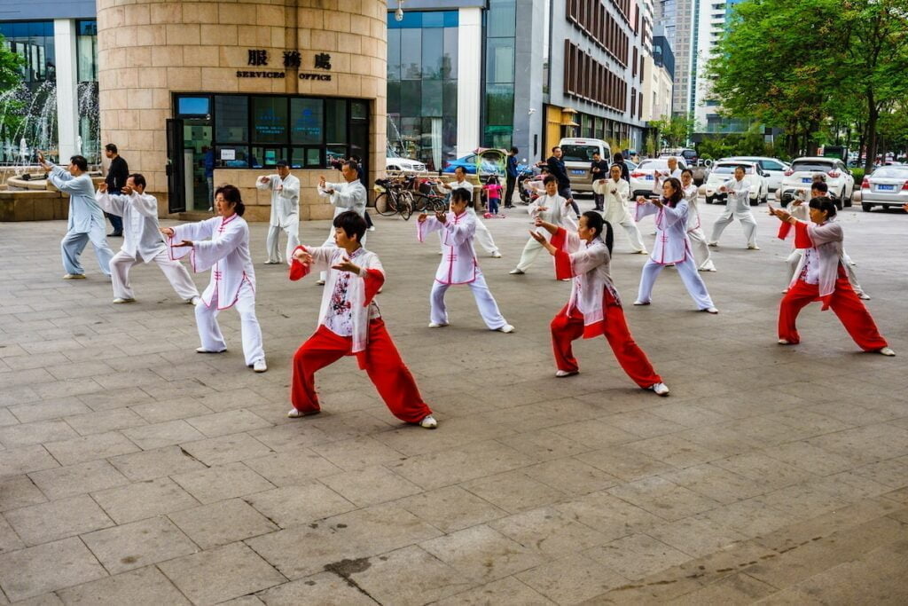 a group of people in red and white outfits dancing
