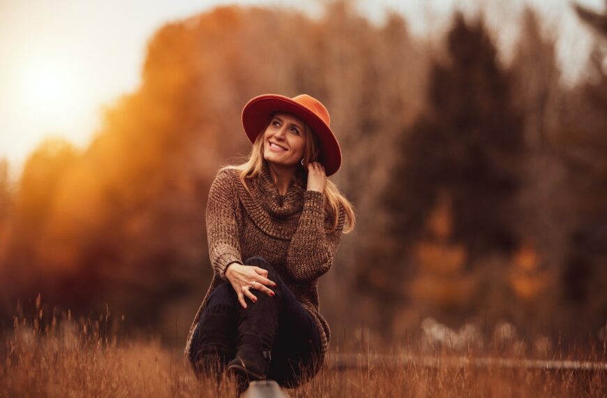 woman sitting on grass field and smiling