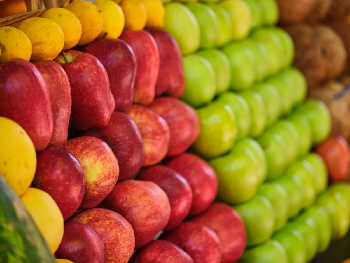 a display of apples and other fruits in a store
