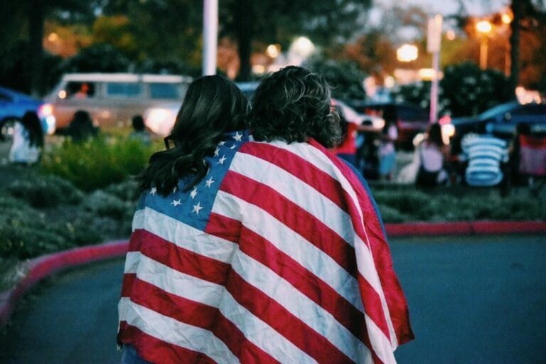 woman and man covered USA flag