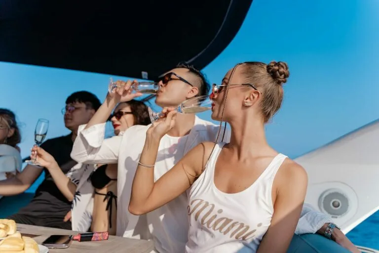 a group of people sitting at a table drinking wine