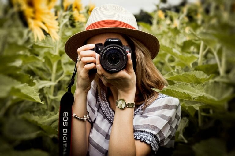woman taking photo of plants